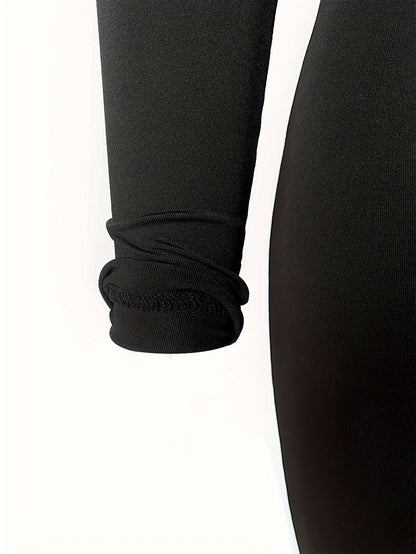 Sportset bestaande uit een crop-top met lange mouwen en een skinny broek met hoge taille